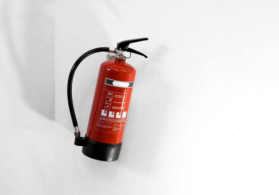 Wall-mounted red fire extinguisher
